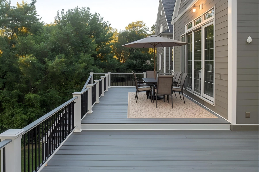 Professional contractor framing a custom wood deck structure securely attached to a residential home